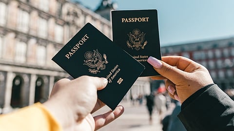 two people holding passports