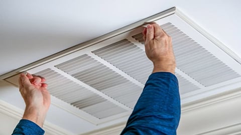 an HVAC technician performing essential maintenance
