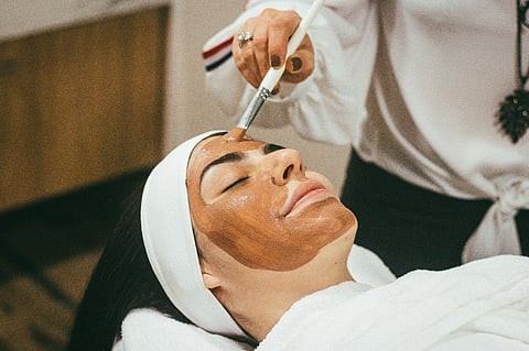 a person receiving a professional facial treatment at a spa