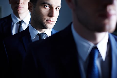 business professionals posing in suits