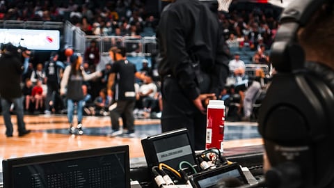 sports analysts at work during an NBA game