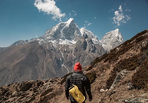 a hiker standing on a trail