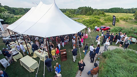 Guests gather beneath the gala tent at SOFO's 2025 Summer Gala in Bridgehampton