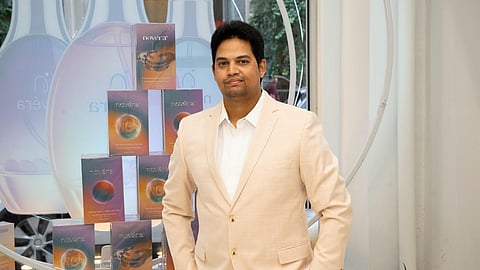 Novéra Skincare founder Zeeshan "Zee" Mohammed stands beside the Gemstone Infusion collection