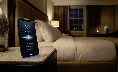AI concierge phone on a bedside table in a modern hotel room.