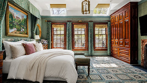 Primary bedroom with custom millwork, skylights, and oversized windows