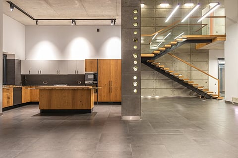 Modern open-concept kitchen and staircase.
