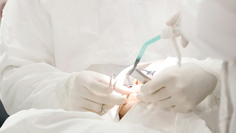 Surgeon operating.