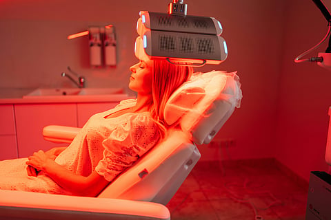 Woman receiving red light therapy.