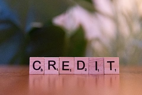 Wooden letter tiles spelling "CREDIT".