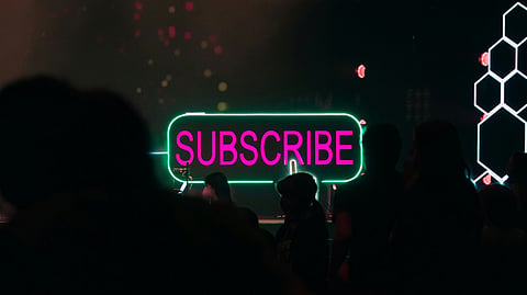 Neon "SUBSCRIBE" sign.