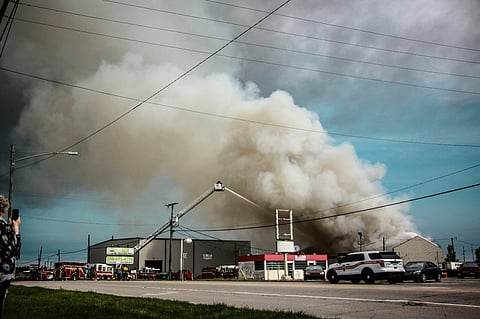 Large building fire with heavy smoke.
