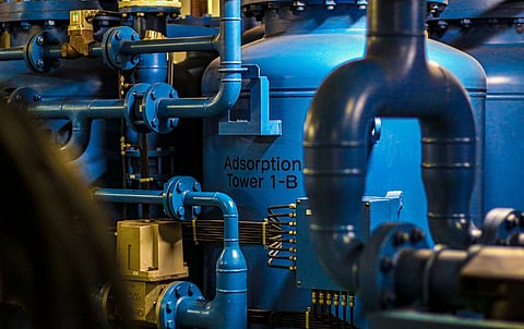 Blue industrial tanks and pipes.