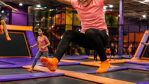 Girl jumping on a trampoline.