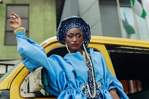 a vibrant blue jacket paired with a matching patterned headwrap