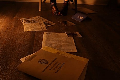 Police files scattered on a floor.