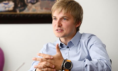 Man in a blue shirt speaking.