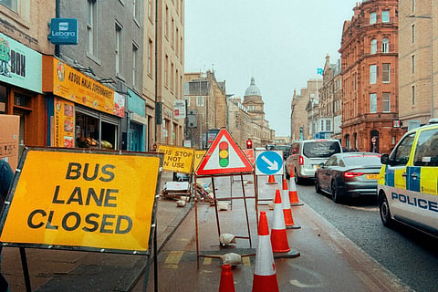 Bus lane closed sign on a city street.
