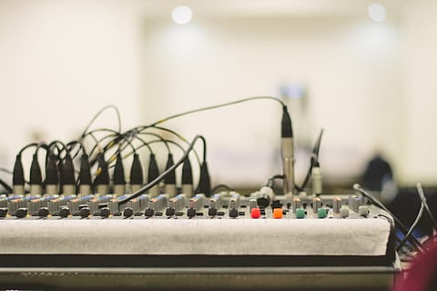 Audio mixing console with cables.