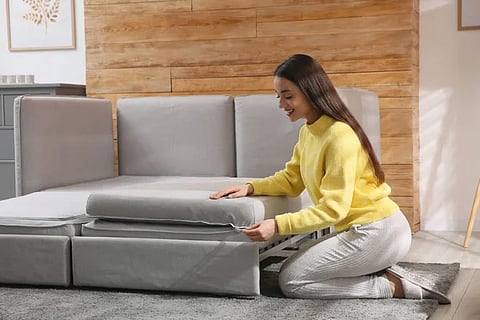 Woman assembling a modular sofa.
