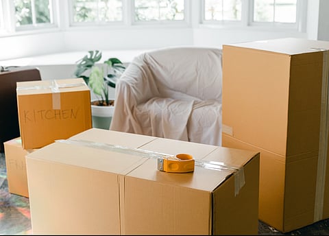 Cardboard moving boxes in a room.