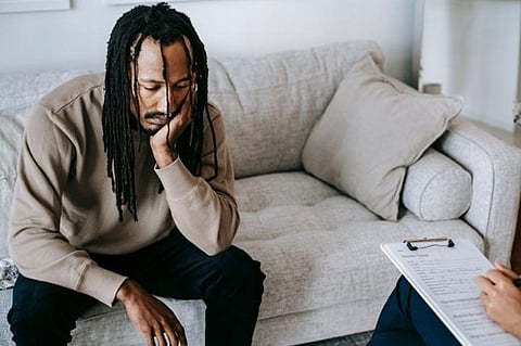 Distressed man in a therapy session.