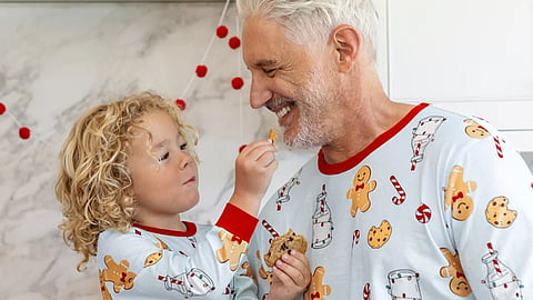 Man and boy in matching gingerbread pajamas.