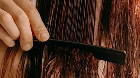 Combing wet red hair.