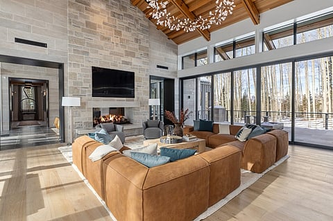Modern living room with a fireplace and leather sectional sofa