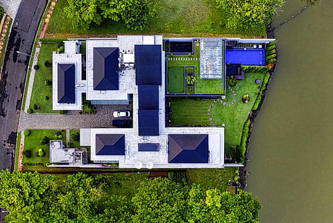 Aerial view of a luxury house by the water.