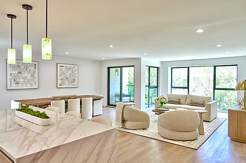 PALMA Beverly Hills, living room light wood floors, cream sofa, rounded boucle armchairs.