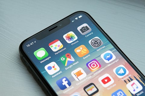 Smartphone home screen with app icons.