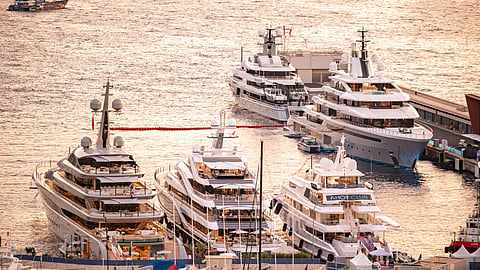 Aerial view of superyachts docked side by side in Port Hercule, Monaco
