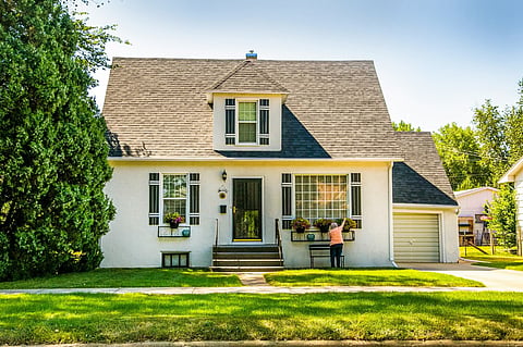 Person gardening outside a house