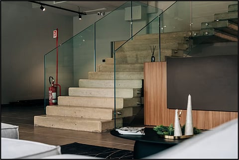 Modern concrete staircase with glass railing.