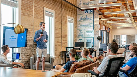 Man presenting to a team in an office meeting.
