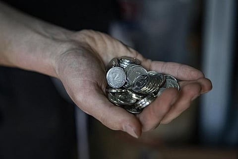 Hand holding coins.