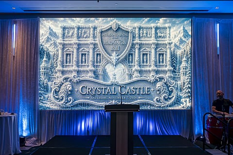 Stage with a podium in front of an ice-blue castle backdrop reading Crystal Castle