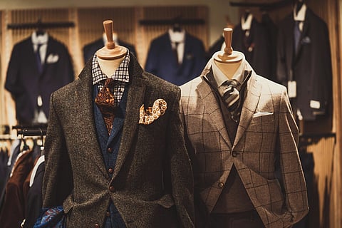 Men's tweed and plaid suits on mannequins.