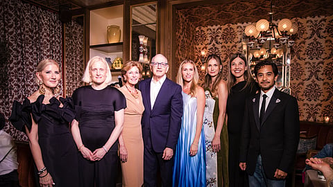 A group of event chairs in evening wear standing together inside the Mother Wolf dining room