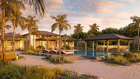 Rendering of beachfront villas with a pool, loungers and a dining pavilion among palms at sunset