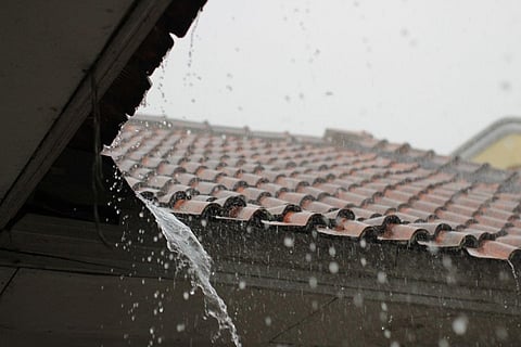 Rain pouring off a tiled roof.