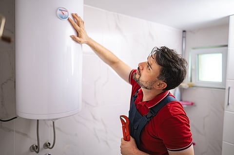 Plumber checking water heater.