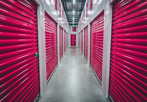 Hallway of red storage units.