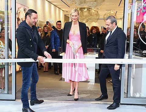 NEW YORK, NY - APRIL 12: (L-R) Robert Buchbauer, Karlie Kloss, and Jean Jacques Sebbag attend as Swarovski brand ambassador, Karlie Kloss cuts the ceremonial ribbon at the brands latest flagship location in New York Citys Times Square in honor of the store opening on April 12, 2018 in New York City. (Photo by Astrid Stawiarz/Getty Images for Swarovski)