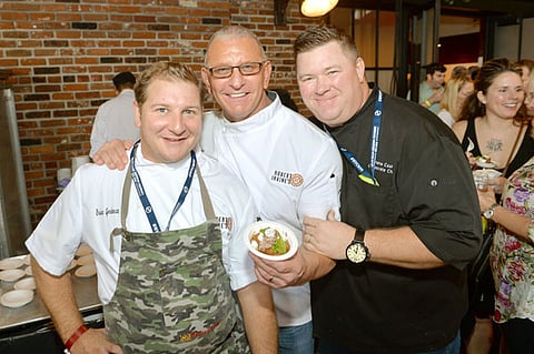 NEW YORK, NY - OCTOBER 14: (L-R) Chefs Brian Goodman, Robert Irvine, and Shane Cash pose with a dish during Pigs and Pints presented by InsideHook hosted by Robert Irvine at The Biergarten at The Standard on October 14, 2017 in New York City. (Photo by Noam Galai/Getty Images for NYCWFF)