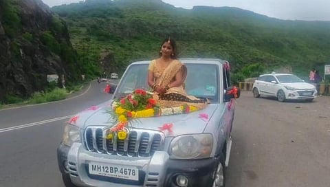 bride sitting on car bonet