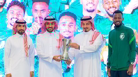 الأمير عبد العزيز الفيصل وياسر المسحل يحملان كأس بطولة آسيا