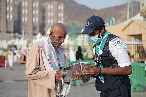 أحد أفراد الكشافة يساعد حاج