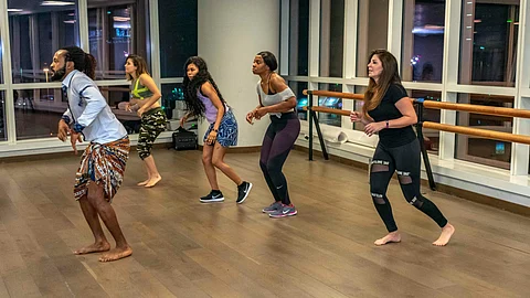a group of people practicing Zumba in a room